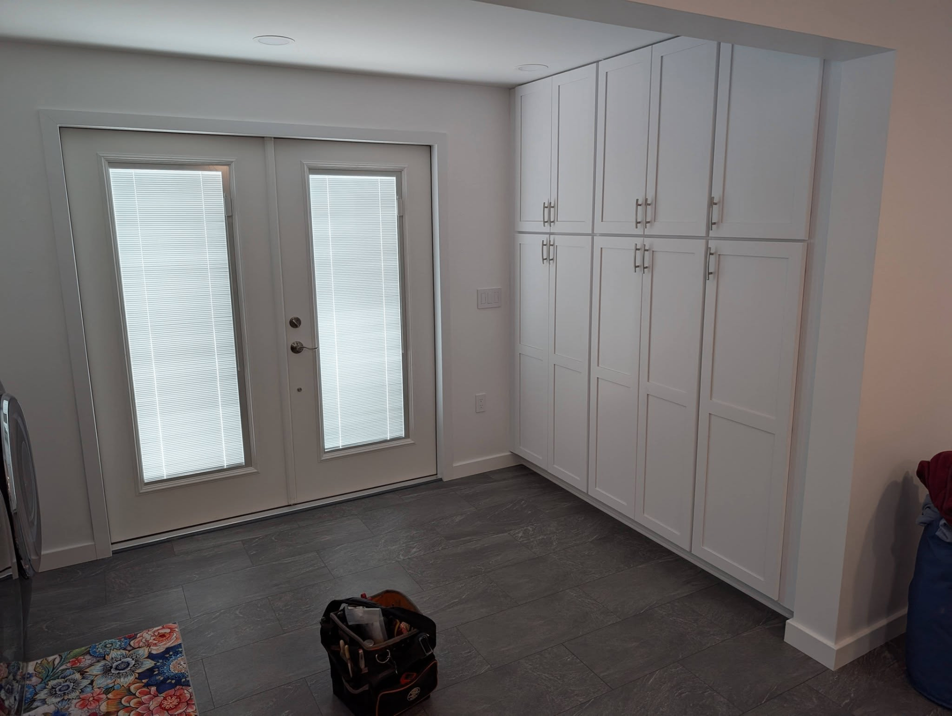 Finished mudroom entry with built-in storage and recessed ceiling lights