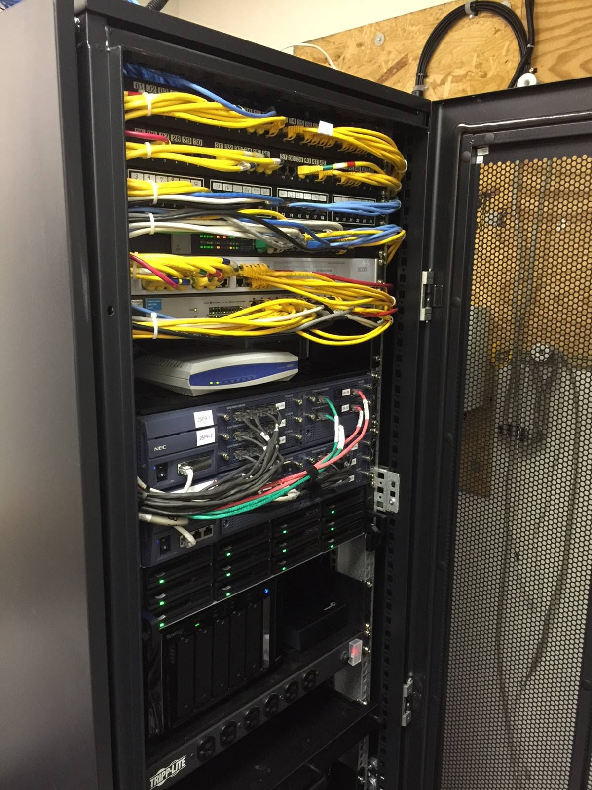 Organized equipment rack with network switches, patch panels, and structured cabling